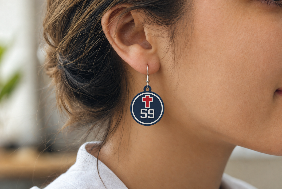 AI-generated styling mockup: Christ Prep round cross-and-number earring, shown with example number 59