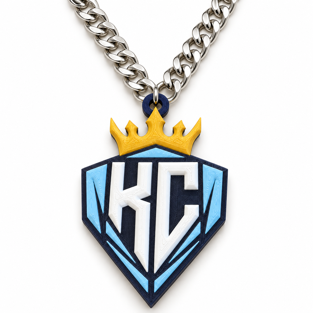 The Diamonds Chain with a blue and white KC crest, yellow crown, and neatly arranged silver-colored V-shaped chain on a white background